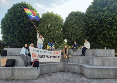 Group of people demonstrating at a monument.