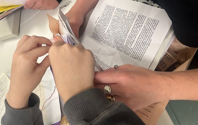 Hands working with a book.