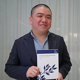Yu Xiang with his thesis.