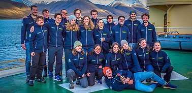 The 21 students in the research school gathered on helicopter deck.