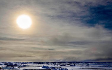Arctic sun, clouds and ice. 