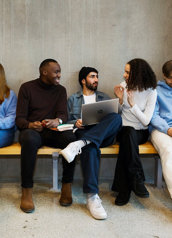 Students sitting on a bench.