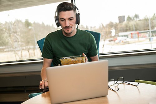 Male student sitting at a computer.