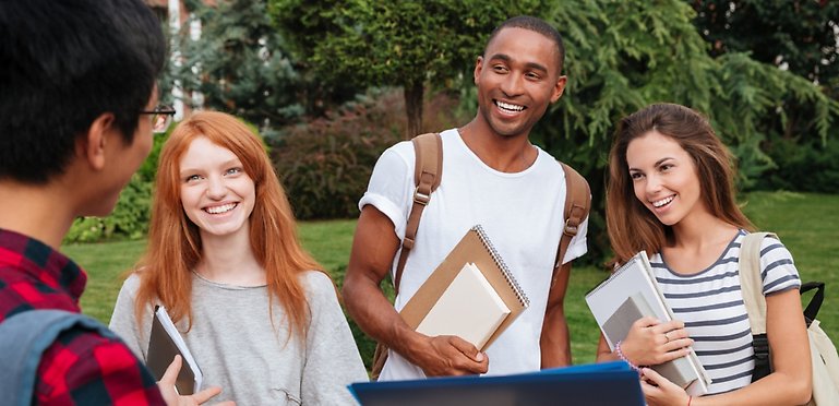 Happy students of different nationalities are talking.