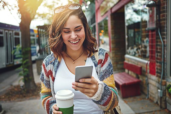 happy woman reading on mobile phone