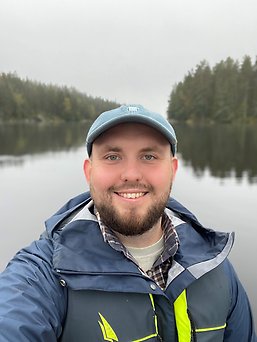 Smiling, young man in a canoot